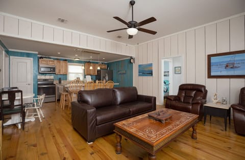 Spacious living room with real leather furniture throughout