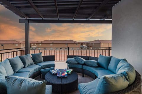 Entertainment balcony with circular sectionals and pergola cover