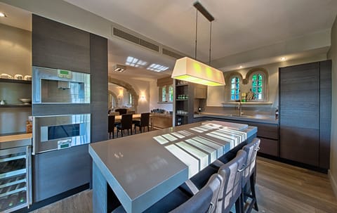 First fully equipped kitchen leading out onto dining terrace 