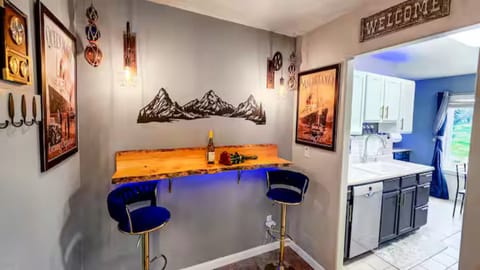 Wine & dine at the stylish bar table—romantic vibes with stunning kitchen view. 