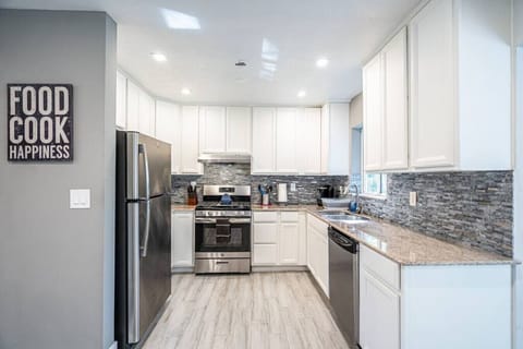 `Stainless steel, granite, and good vibes - this kitchen is ready to cook up something delicious (and maybe a little bit fancy).`