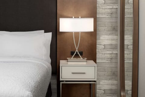 Laptop workspace, iron/ironing board, bed sheets