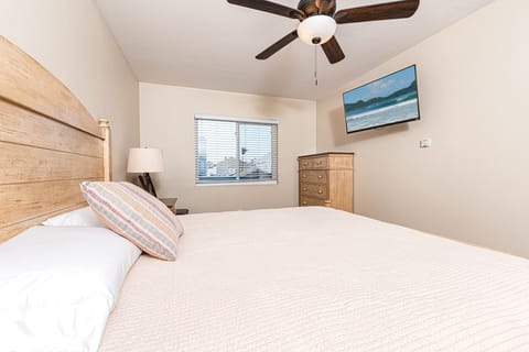 The bedroom includes a king bed, TV, and en suite bathroom.