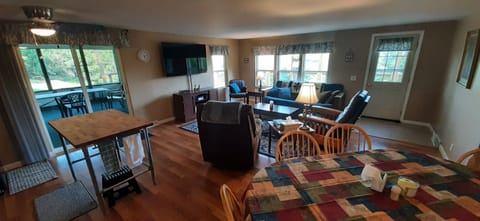 Living/dining/kitchen area w. wide screen TV and access to deck and screen porch