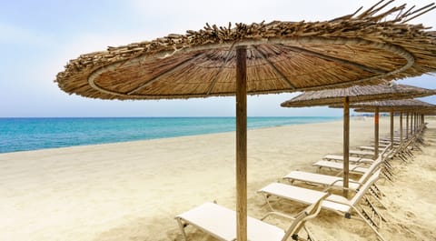 On the beach, sun loungers, beach umbrellas, beach bar