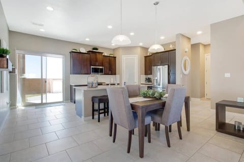 Dining room area seating for four plus a breakfast bar with seating for four.