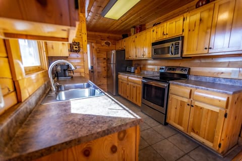 Kitchen fully stocked with place settings and cookware