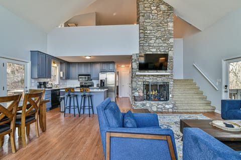 Cathedral ceiling with a beautiful stone fireplace running through the house