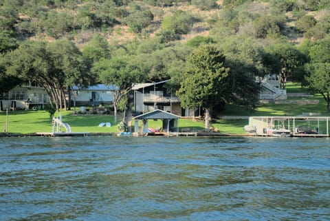 House and boat dock in center, view from across cove.