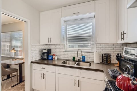 Enjoy the full kitchen with a refrigerator, oven, stove, microwave, coffee, creamers, mixers, spices, pots, pans, cooking supplies, cutlery, cups, plates, bowls, utensils, small appliances, view of the backyard, and many more essentials.