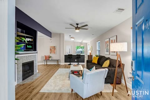 Spacious and comfortable living room with fireplace and large smart tv