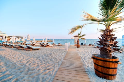 On the beach, beach cabanas, sun loungers, beach umbrellas