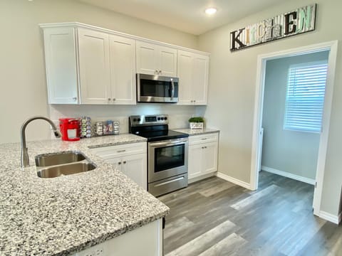 NEW kitchen with stainless steel appliances and granite countertops