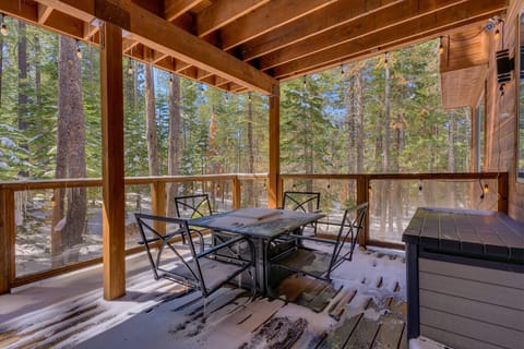 - Covered deck with forest views and patio seating
- Snowy escape with string lights and fresh mountain air
- Outdoor dining area perfect for cozy cabin stays