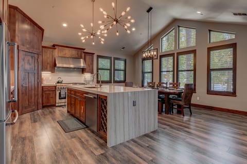 - Open kitchen and dining area with vaulted ceiling
- Spacious layout with modern lighting and seating
- Large island for meal prep and family gatherings