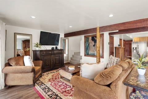 Downstairs living area with living room, fireplace, and deck space.