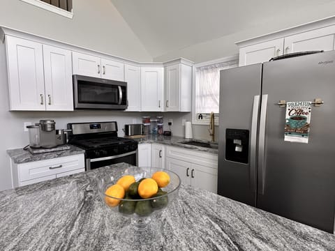 Fully equipped kitchen with stainless steel appliances and granite countertops.