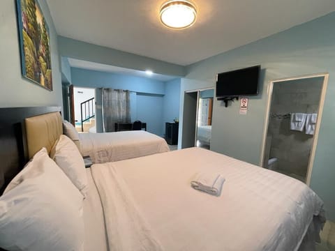 Family Room, 2 Queen Beds | Iron/ironing board, free WiFi, bed sheets