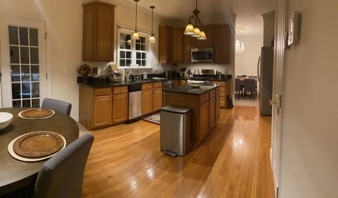 Full size kitchen with island, granite countertops and equipped for cooking