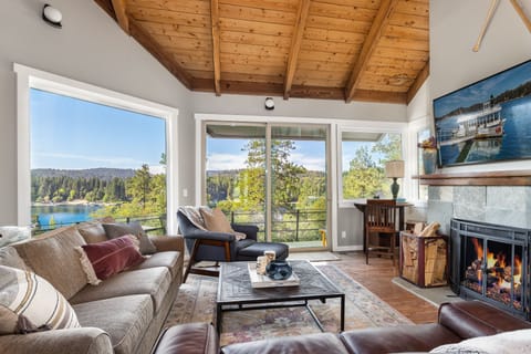 Great room with lake views, access to  master deck, and decorative fireplace
