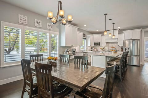 6. Dining area w/ dining table for six and a chandelier.