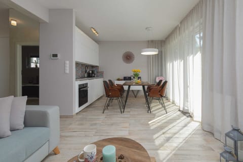 Elegant and comfortable kitchenette and lounge room with a corner sofa, TV and access to the terrace.