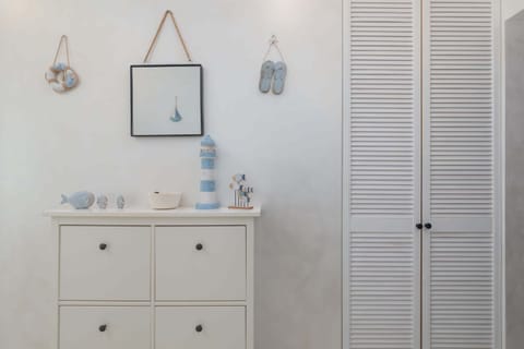 Bright apartment space with a wardrobe and chest of drawers.