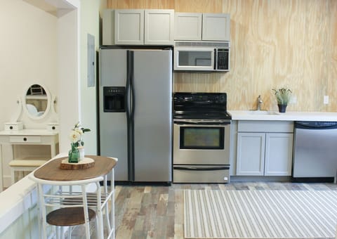 Kitchen is fully stocked with up to date appliances and utensils for making meals. 2 person seating in kitchen for dining.