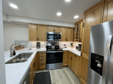Fully stocked kitchen with Keurig and drip coffee maker and spices.