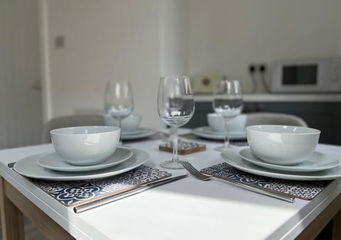 Table set ready for your family to eat here with a room full of day light 