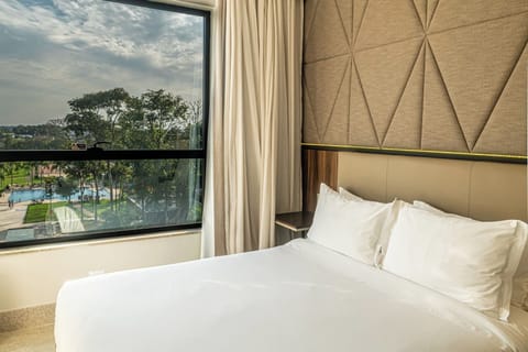 Deluxe Room, 1 Bedroom, Pool View | Minibar, in-room safe, laptop workspace, blackout drapes