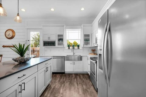 Freestyle's kitchen with stainless appliances, apron sink, and granite island.