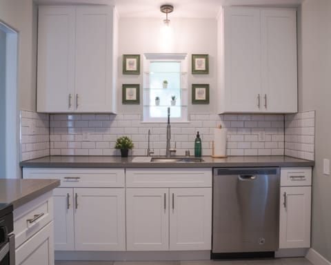 Remodeled kitchen with filtered water, stove, oven, microwave, & dishwasher.