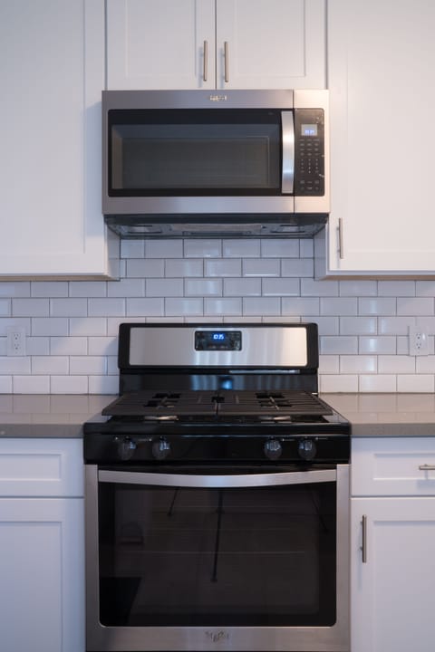 Kitchen stove & over the range microwave. Generous counter area.