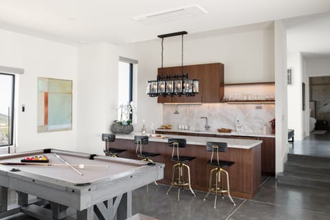 Rec room with a wet bar and games.