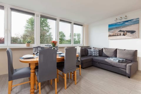 Relax in the stylish living room with a comfortable sofa and modern decor.