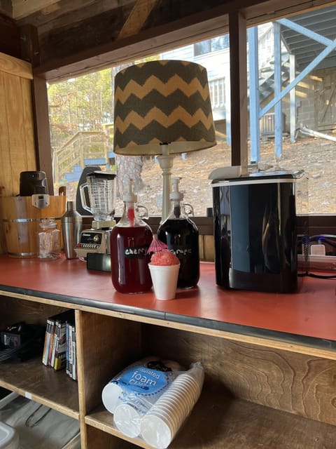 Pavilion snow cone bar with ice maker and grape & cherry syrup in mini fridge