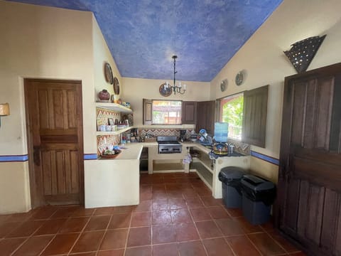 Simple Kitchen. Stocked with pots, pans, plates, glasses, etc.