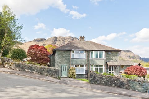 Green Croft Cottage in Coniston with Lake District mountains behind