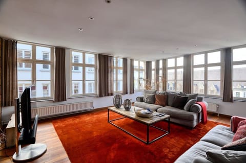 Our lovely living room area complete with a comfy sofa couch, coffee table, a TV and a beautiful carpet to make it comfortable
