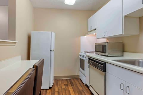 Full-size fridge, microwave, stovetop, cookware/dishes/utensils