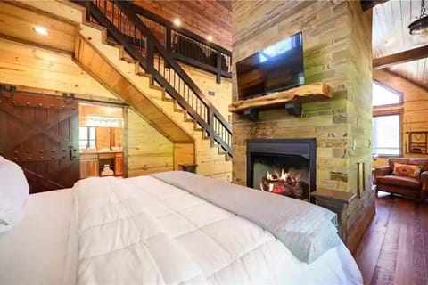 King bed and fireplace from other side. TV here too.