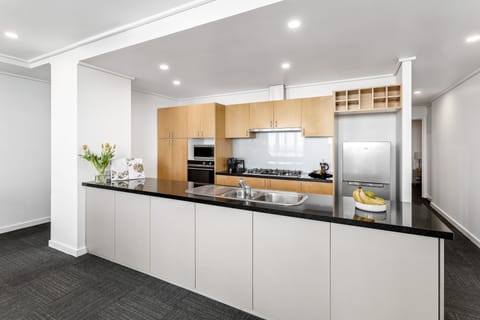 Deluxe Three Bedroom Apartment | Private kitchen | Full-size fridge, microwave, oven, stovetop