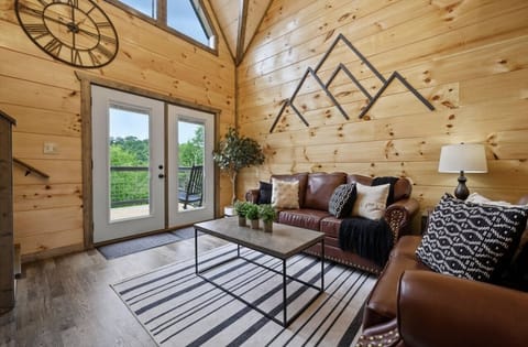 Main living room with high vaulted ceilings. Has walk out to upper patio deck.