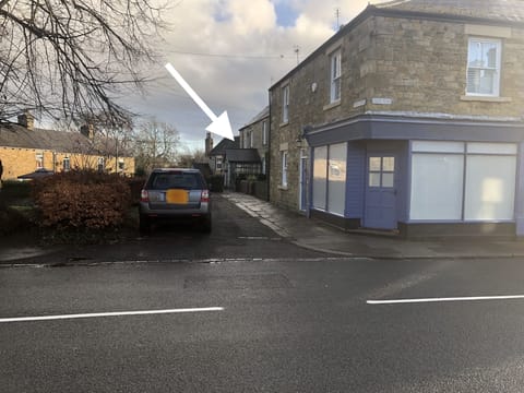 View of house from the road.  Parking available next to front gate.