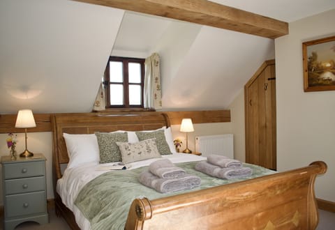 Master bedroom with king-size sleigh bed, wardrobe and ensuite shower room