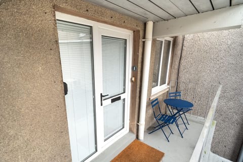 The property has a small seating area outside the front entrance