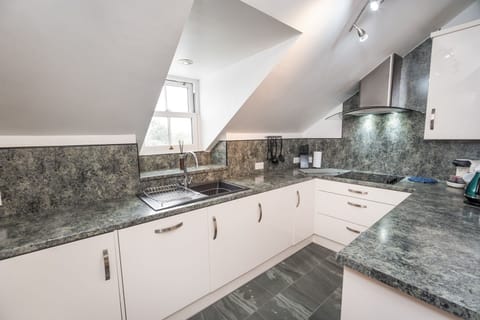 There is a step down to the kitchen area, fitted with modern Siemens integrated appliances