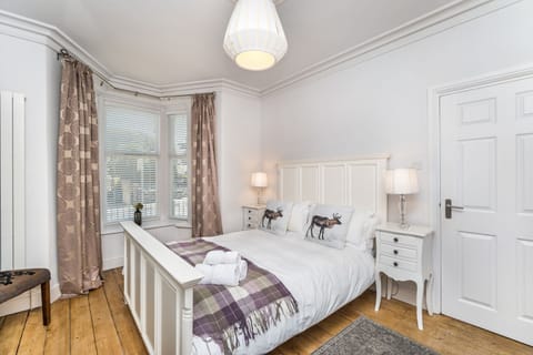 The ground floor bedroom has a king sized bed, wardrobe and bed side tables