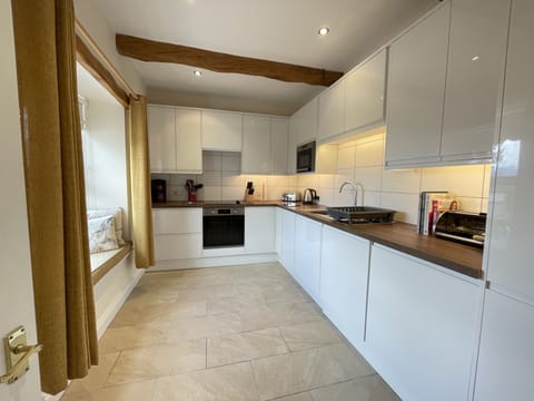 A beautiful modern kitchen can be found at the rear of the property